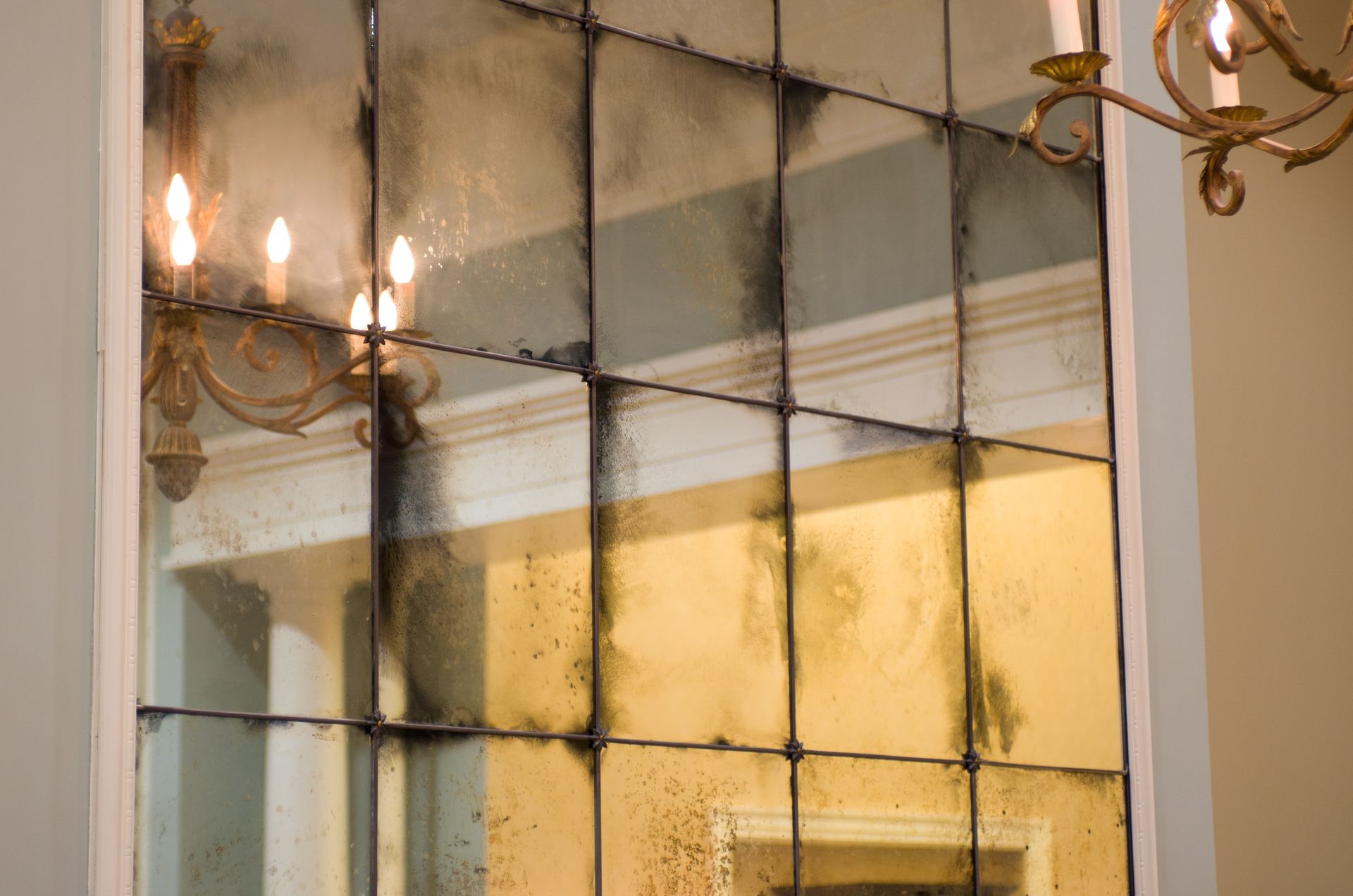 A wall of antique mirrors used as architectural glass.