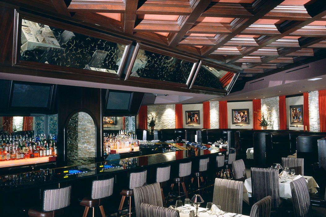 A restaurant with tables and chairs and a bar