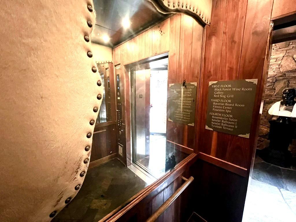 An antique mirror elevator cab.