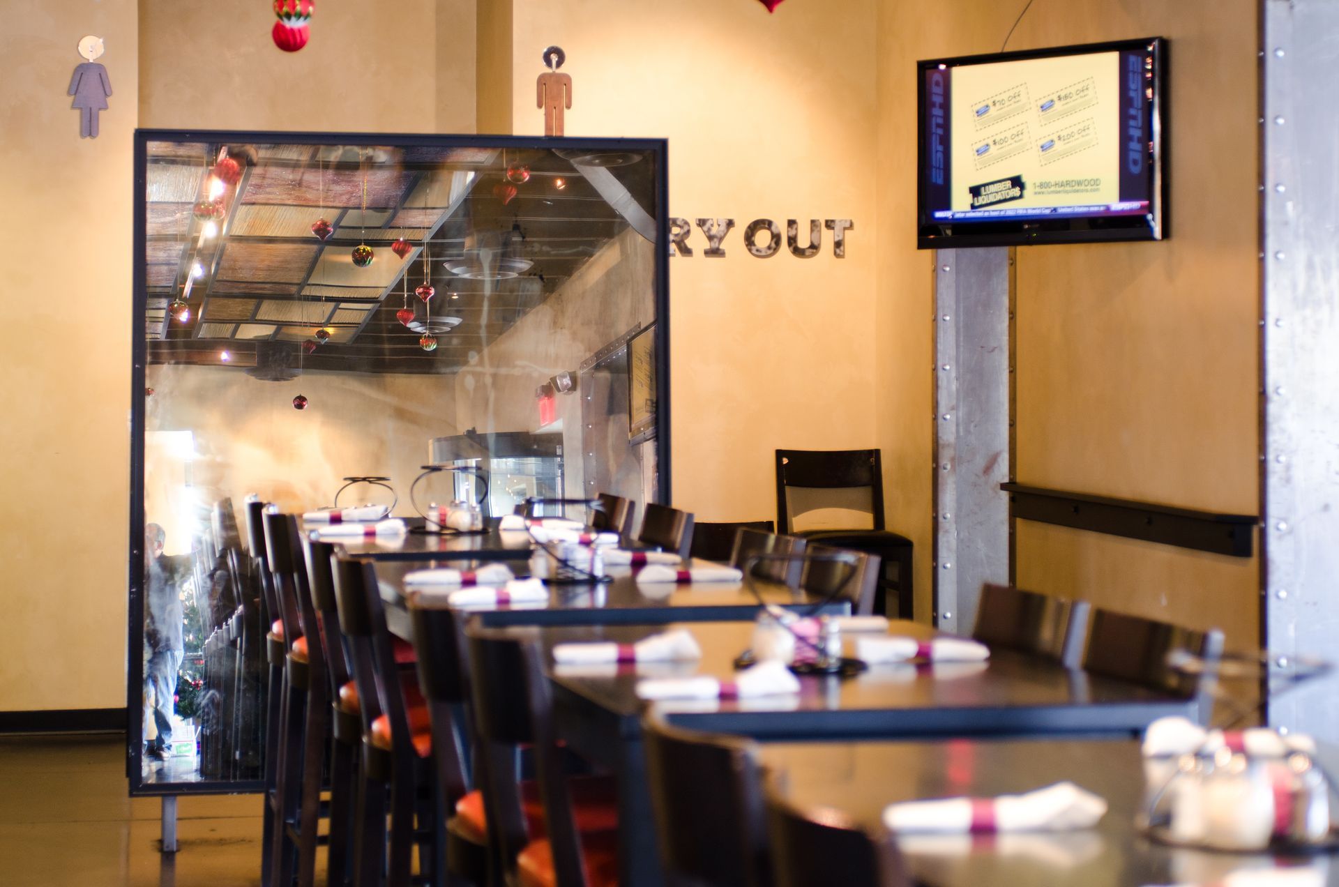 A restaurant with tables and chairs and a sign that says ry out