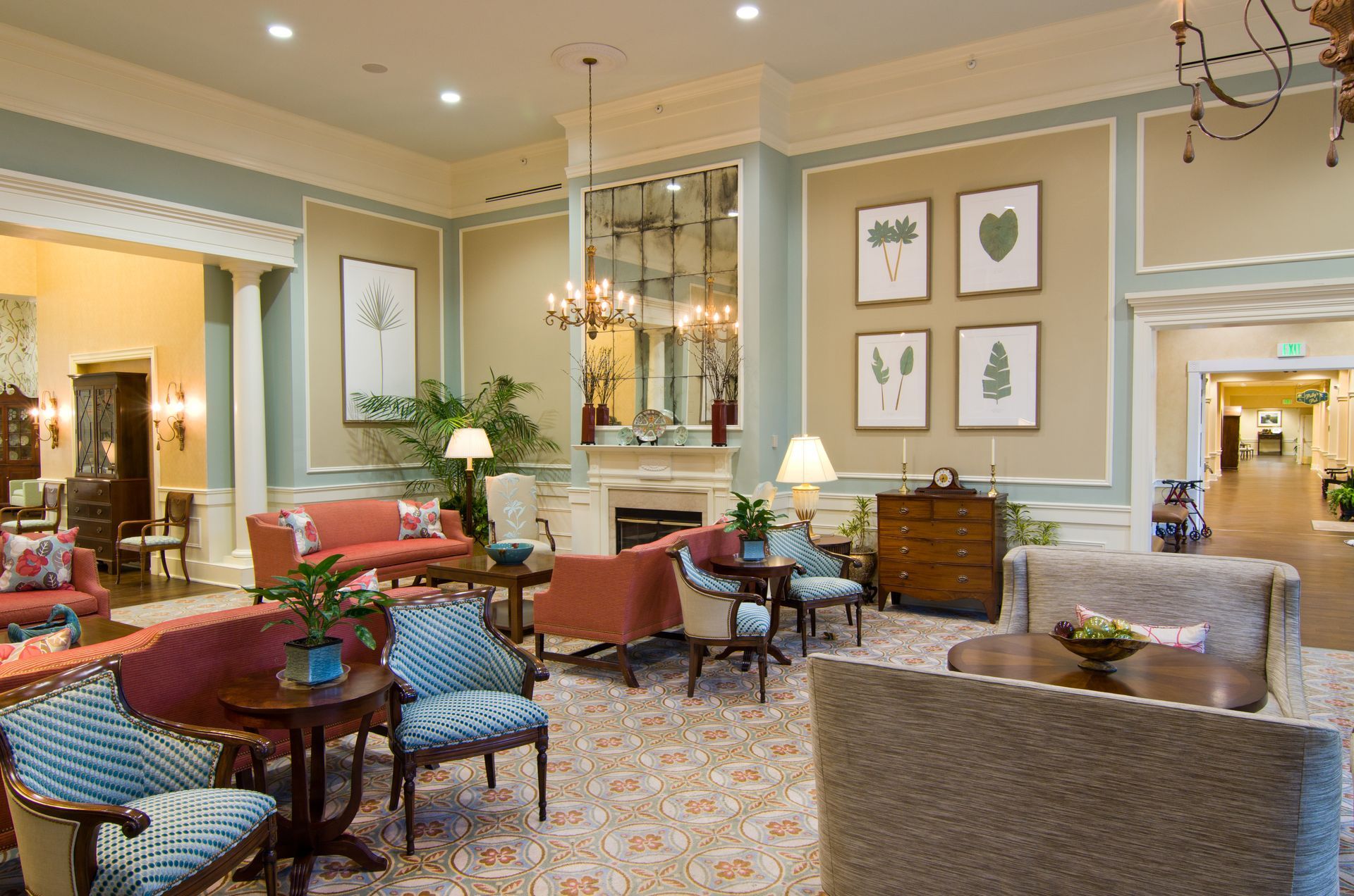 A living room filled with furniture and a fireplace and antique mirrors