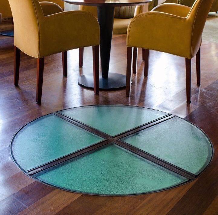 A table and chairs in a room with a glass floor
