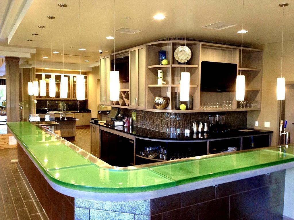 Interior view of a modern bar with a green countertop