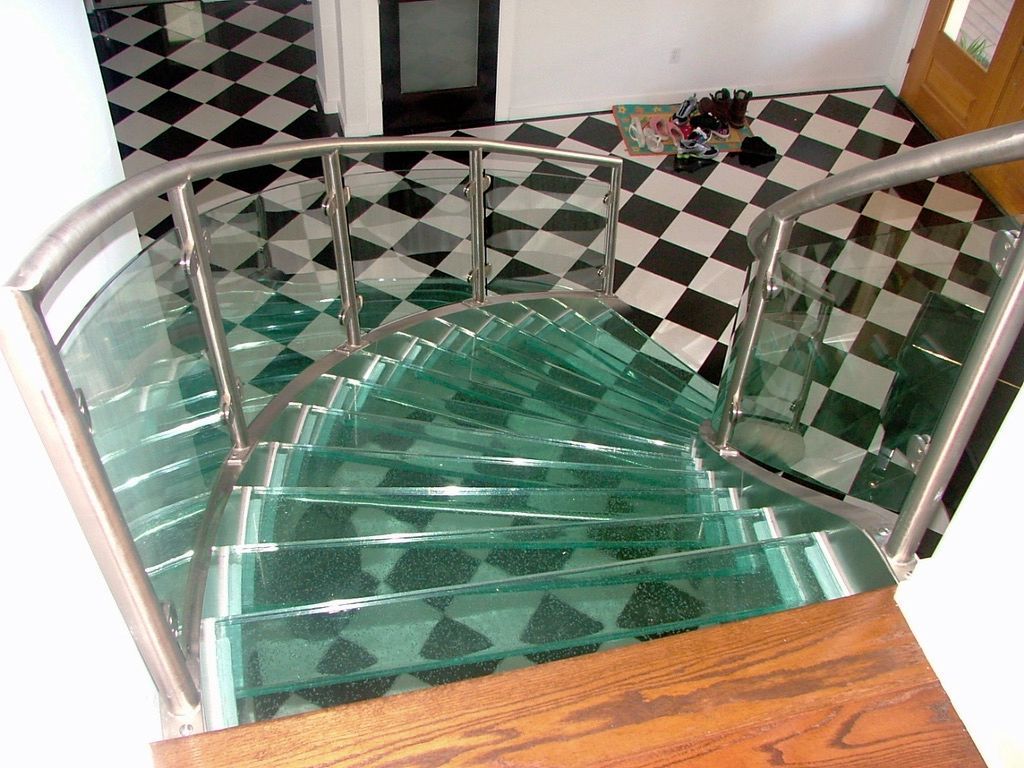 A glass staircase with a checkered floor in the background