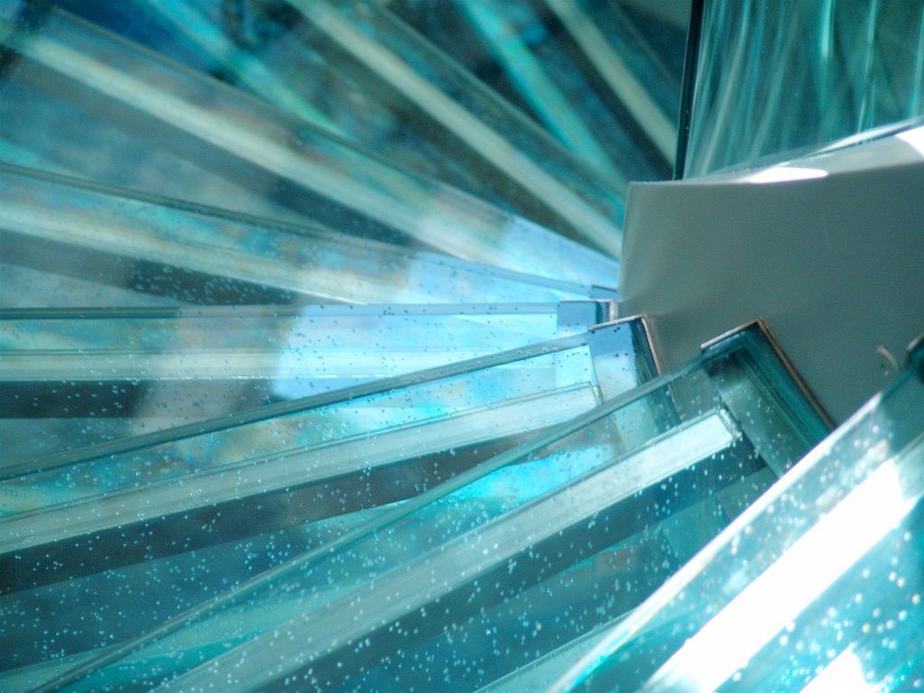 A close up of a spiral staircase made of glass