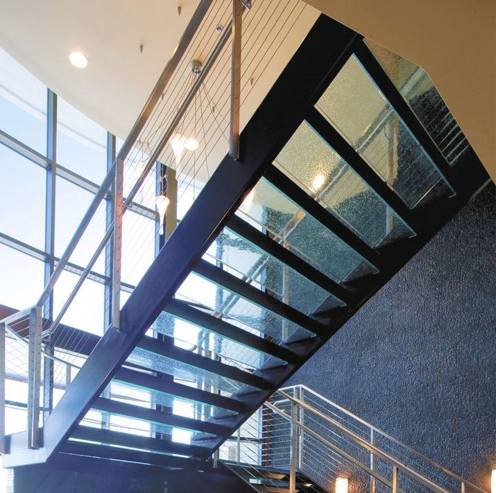 A staircase with glass steps and a metal railing
