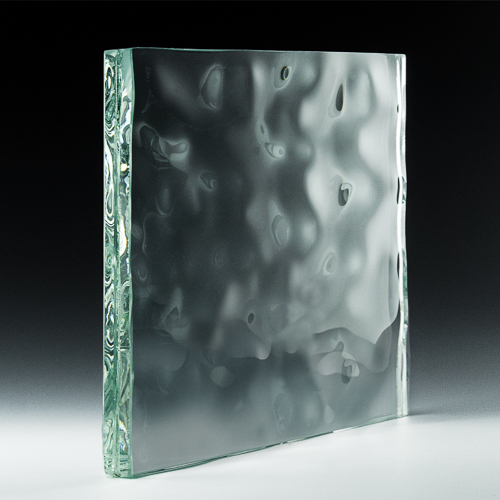 Textured glass block, clear with wavy surface, resting in a studio with dark background.