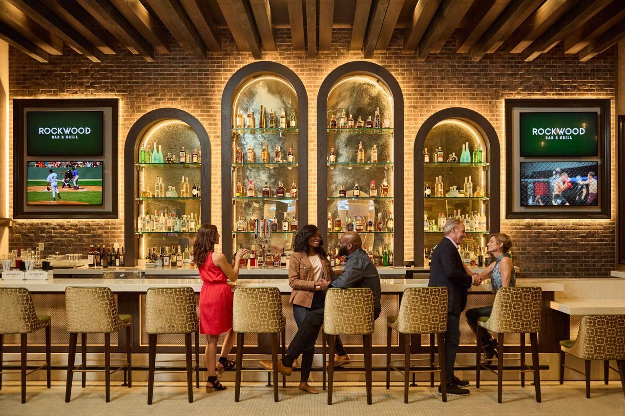 A group of people are sitting at a bar in a restaurant