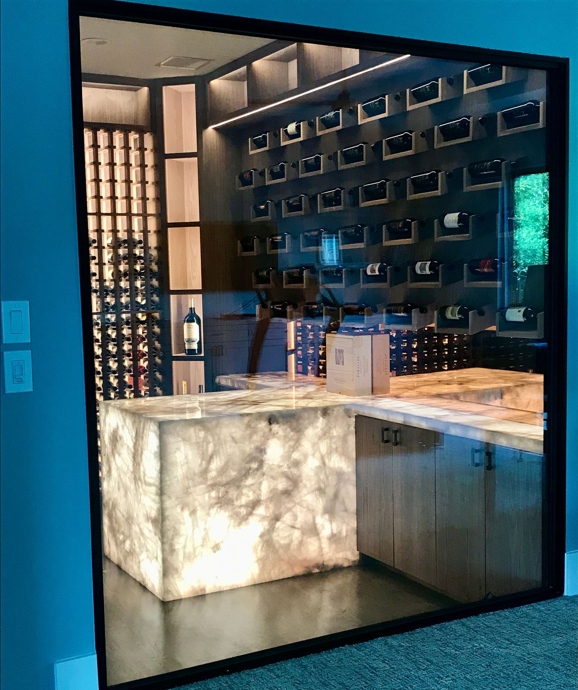 A large antique mirror shows a kitchen with a marble counter top.