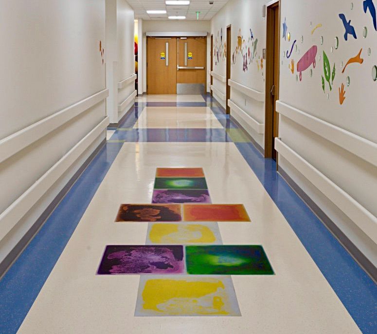 A hallway with a liquid lava filled hopscotch pattern on the floor