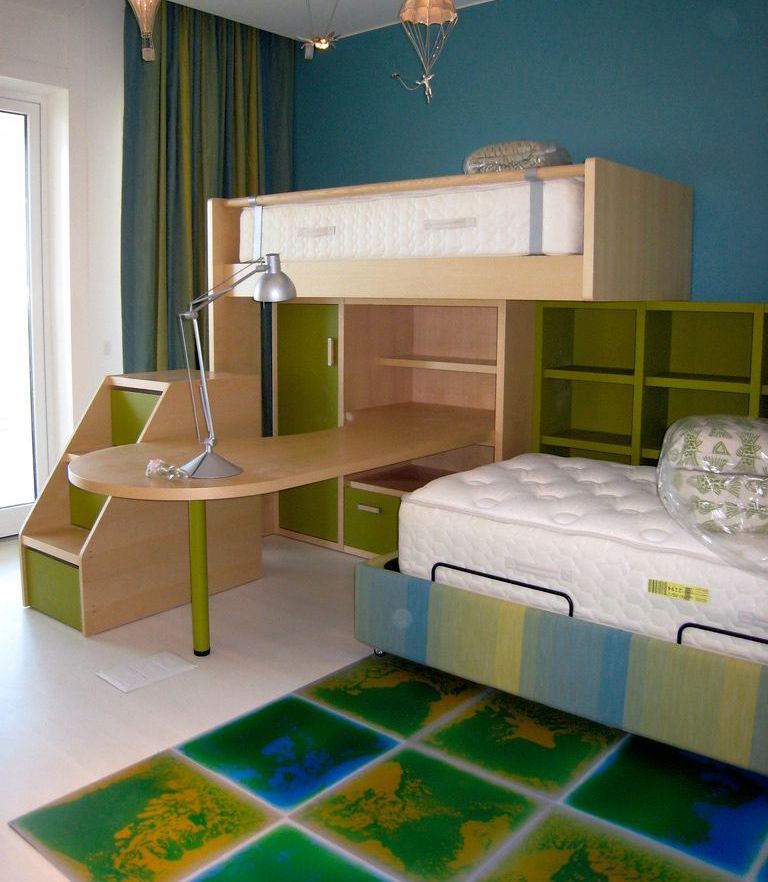 A bedroom with a bunk bed and a desk