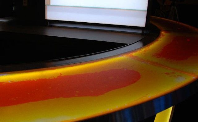 A computer monitor is sitting on top of a liquid lava bartop