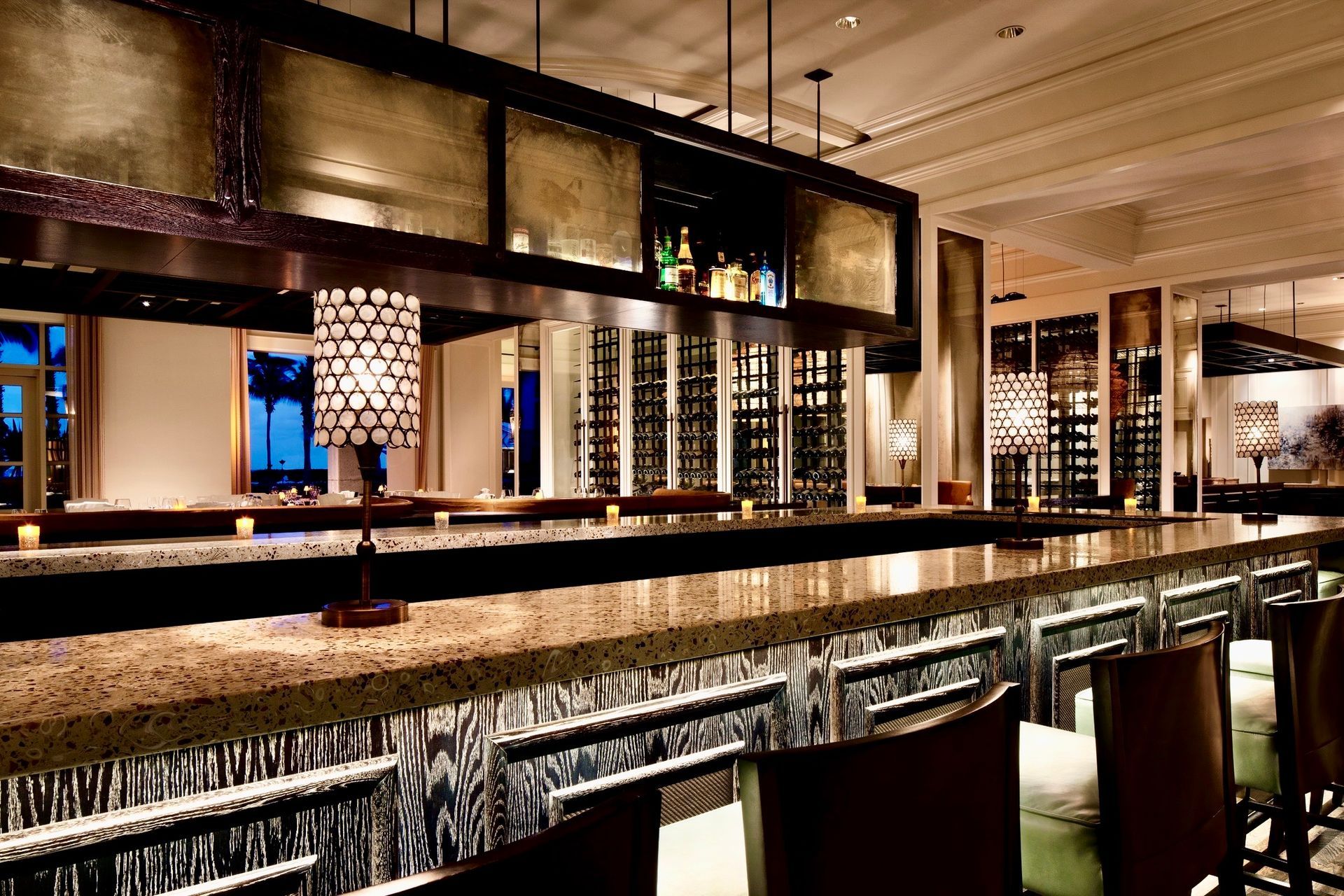 A restaurant with a long bar and chairs