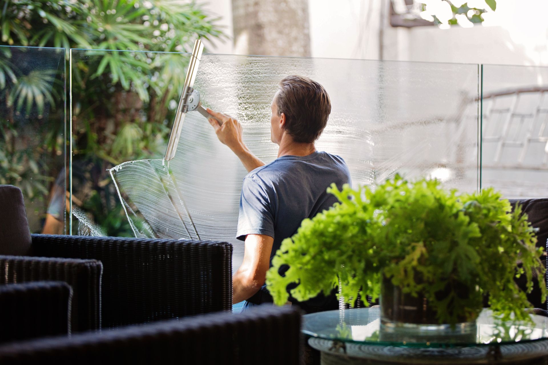 A man cleaning glass windows so they're free of streaks