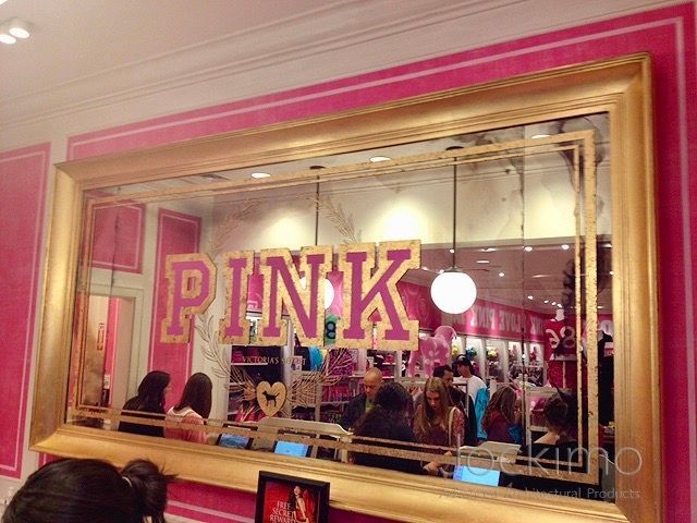 A large antique mirror at Victoria Secret with the word pink on it