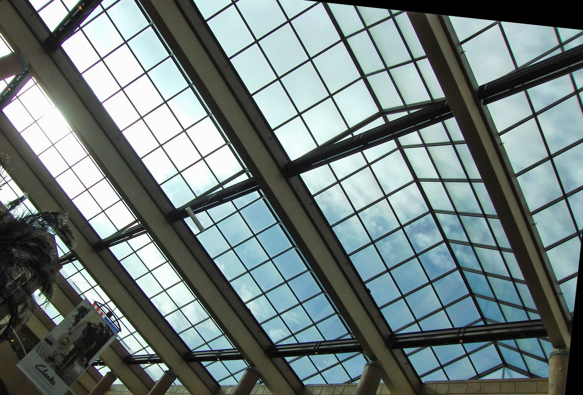 A commercial building with glass skylights and windows for the roof.