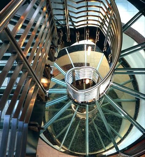 Looking up at a glass tread spiral staircase in a building