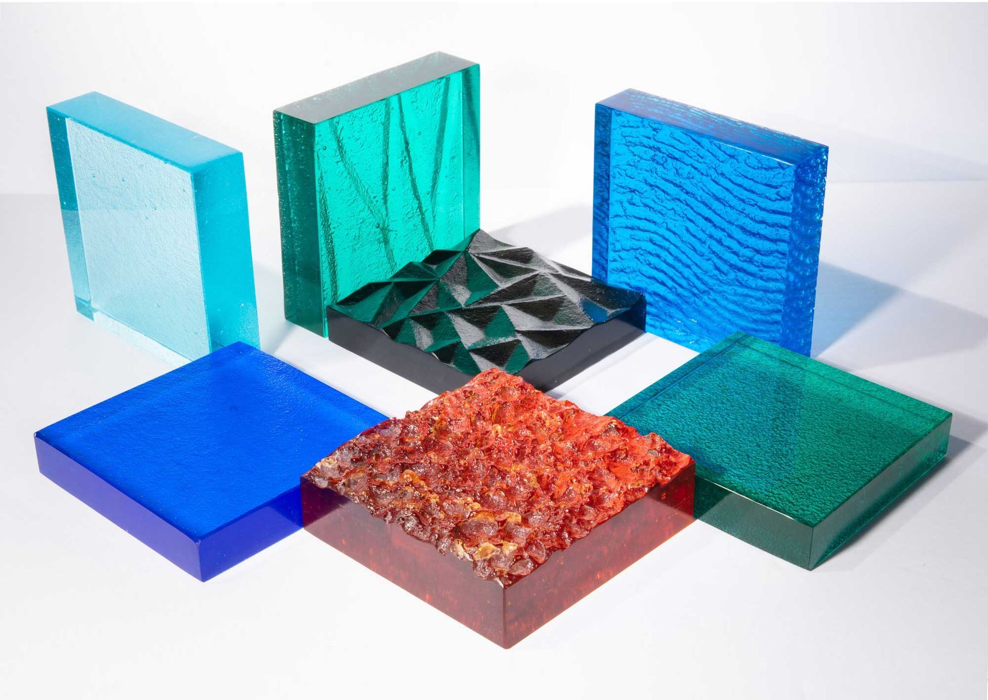 A variety of ThickGlass glass samples in colors ranging from orange to blue.