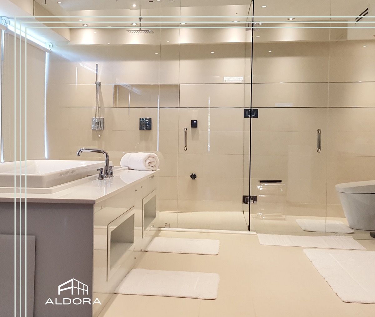 A bathroom with a walk in shower and a glass door.