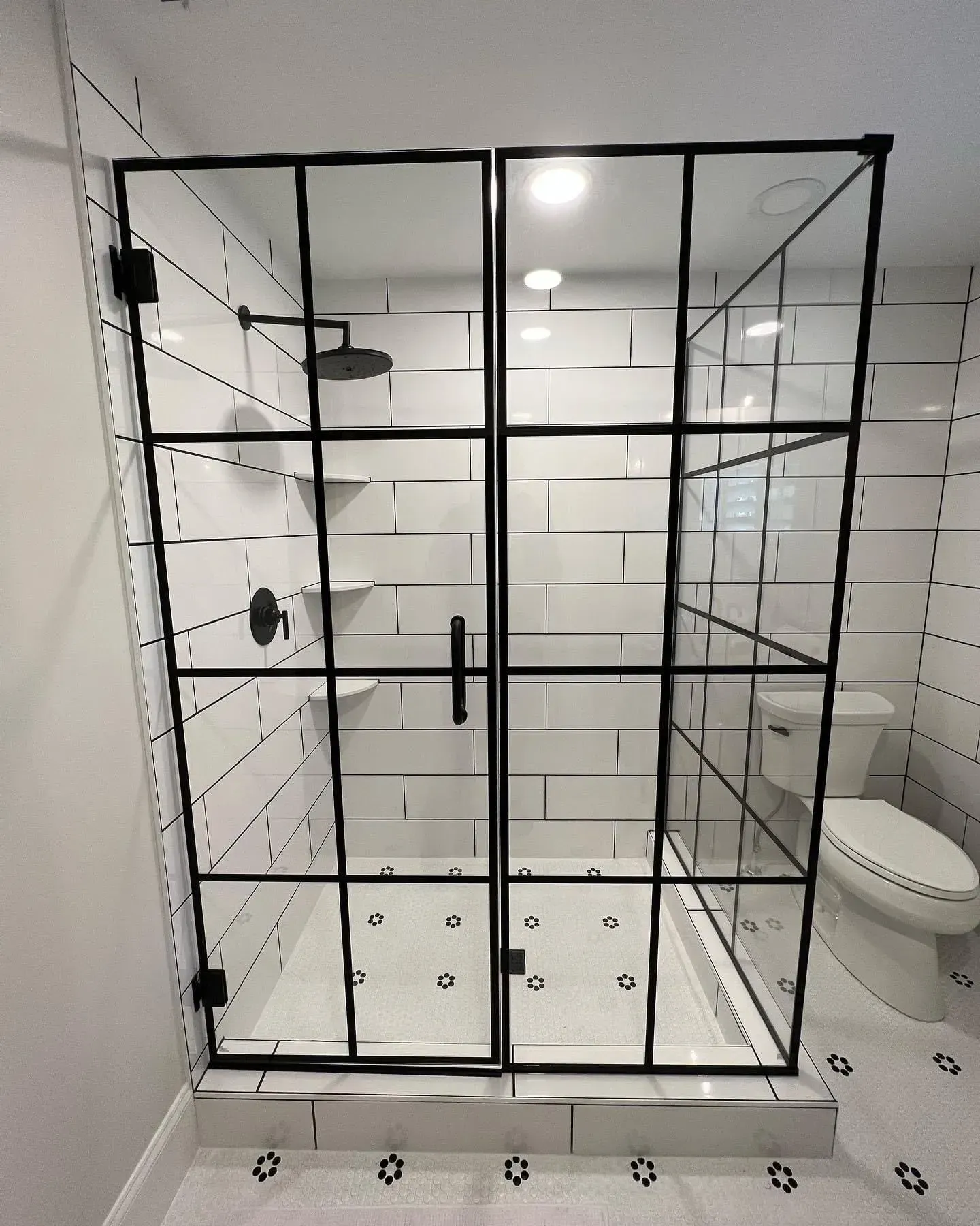 A bathroom with a walk in shower and a toilet
