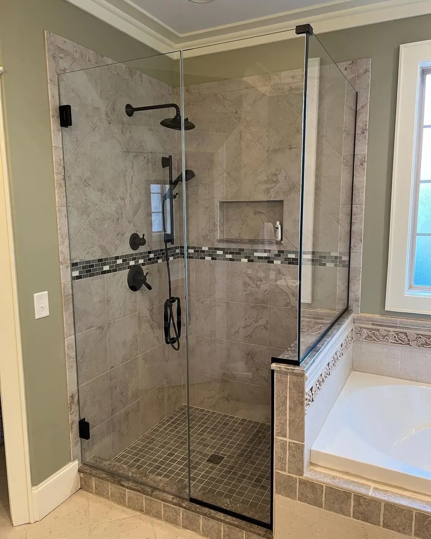 A bathroom with a walk in shower and a bathtub.