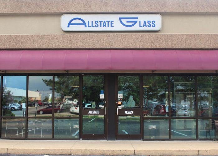 A store front with a sign that says allstate glass