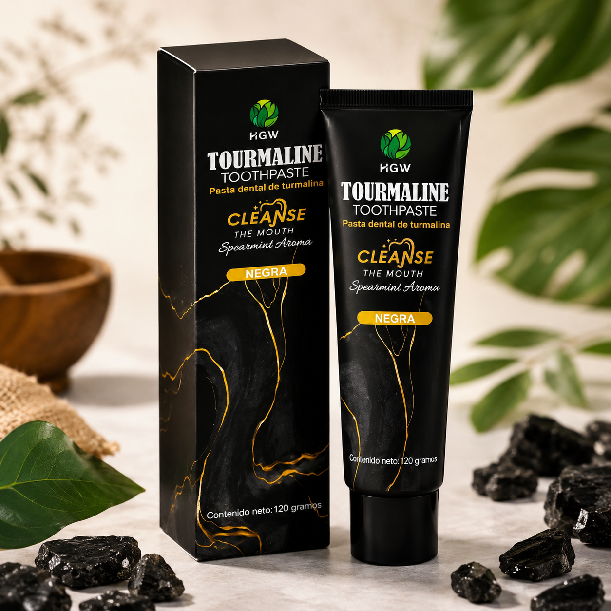 Tubo y caja negros de pasta de dientes de turmalina con trozos de carbón vegetal sobre fondo beige.