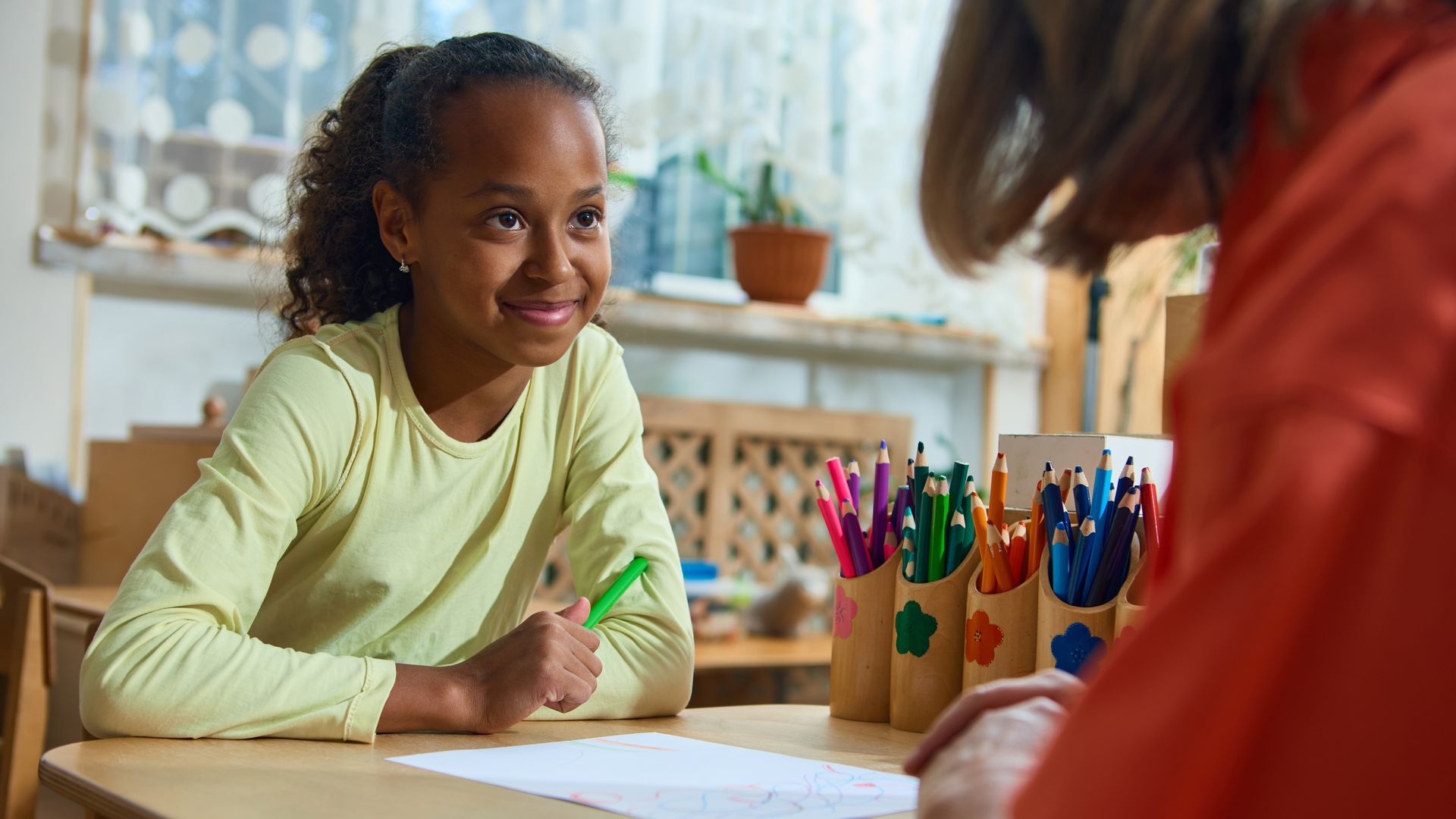 Woman wearing oversized jeans, smiling, holding out sides, showing weight loss. Light blue background. Woman wearing oversized jeans, smiling, holding out sides, showing weight loss. Light blue background.