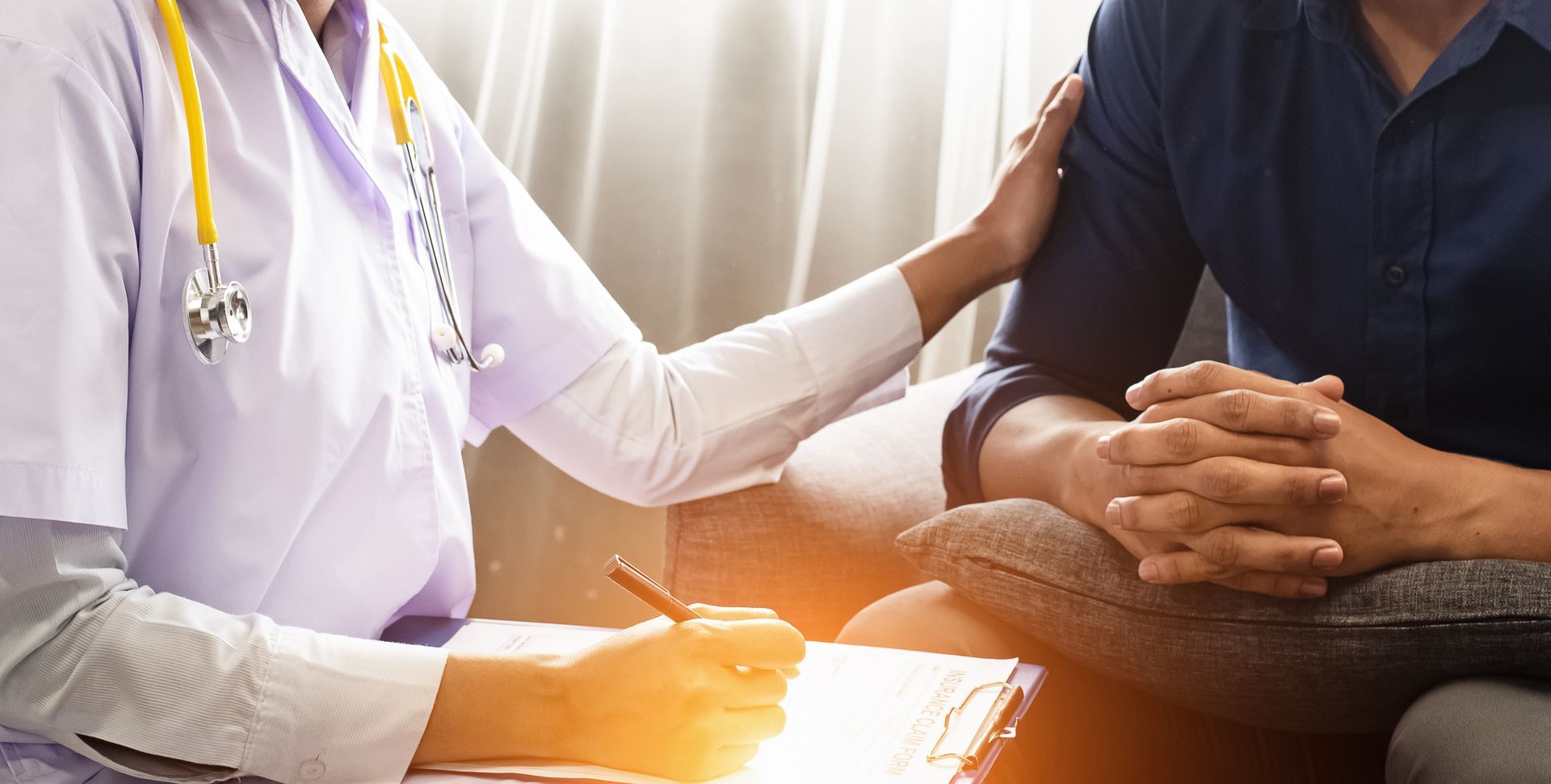 Doctor measuring patient's waist in a bright office. Fruits on desk.