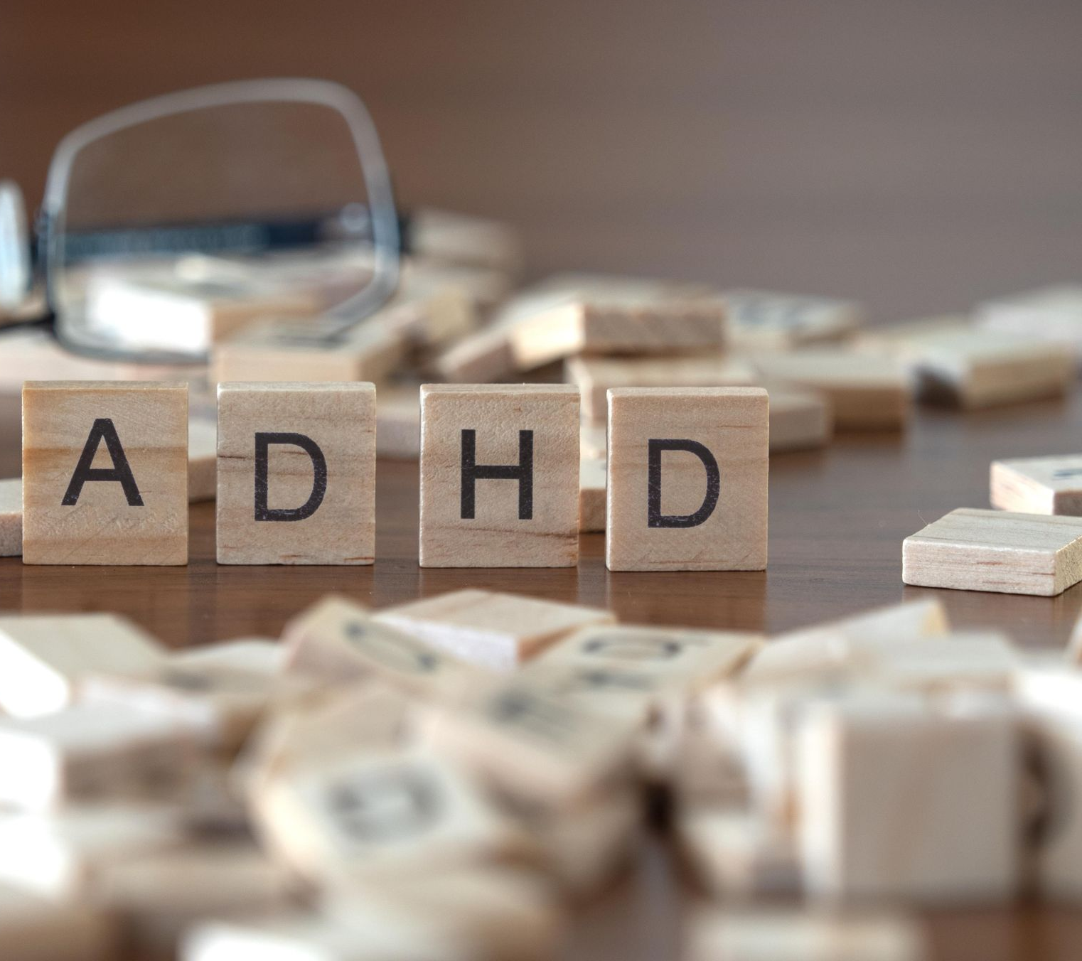 Woman wearing oversized jeans, smiling, holding out sides, showing weight loss. Light blue background. Woman wearing oversized jeans, smiling, holding out sides, showing weight loss. Light blue background.