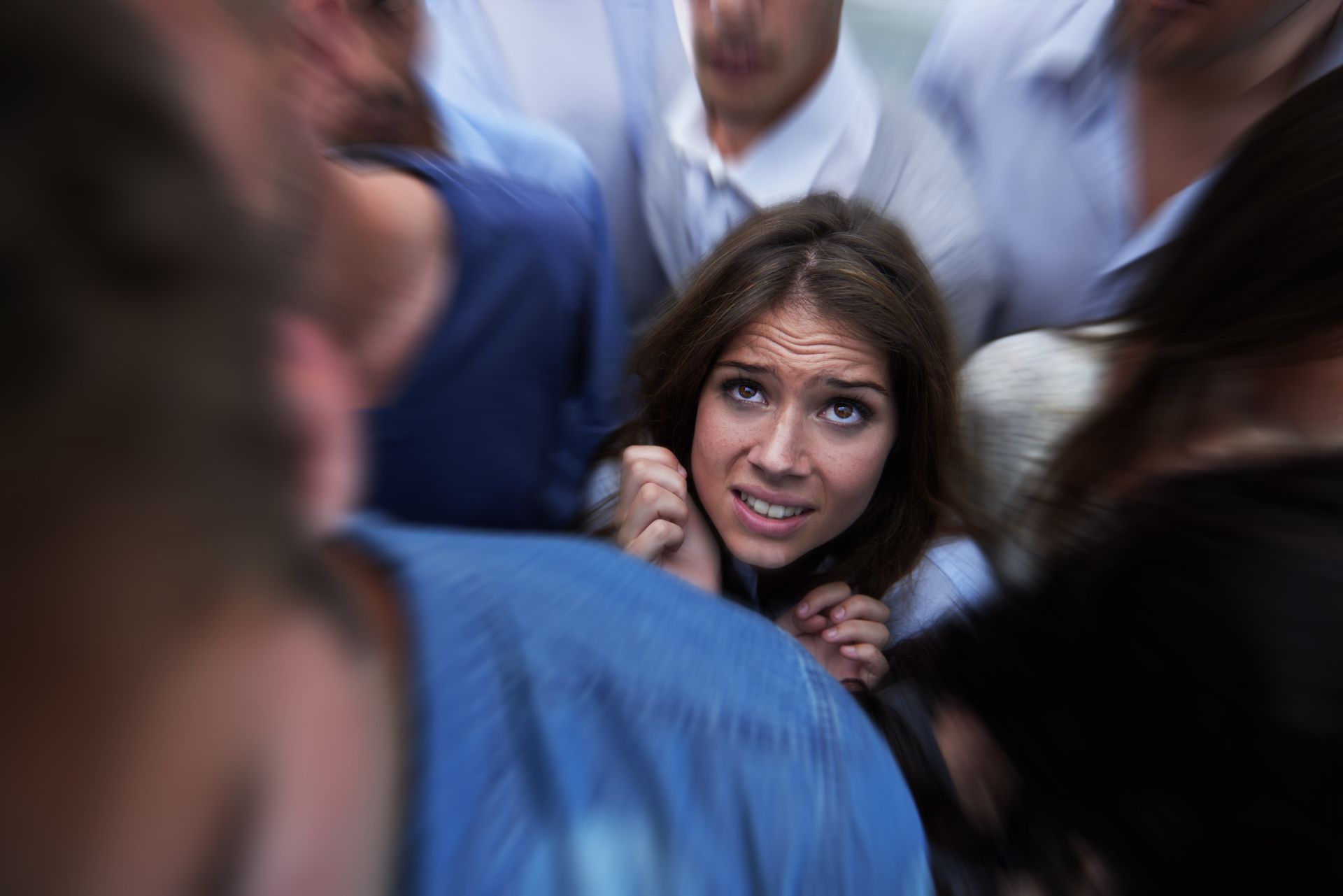Woman with a panicked expression in a tightly packed crowd, surrounded by blurry figures. Woman with a panicked expression in a tightly packed crowd, surrounded by blurry figures.