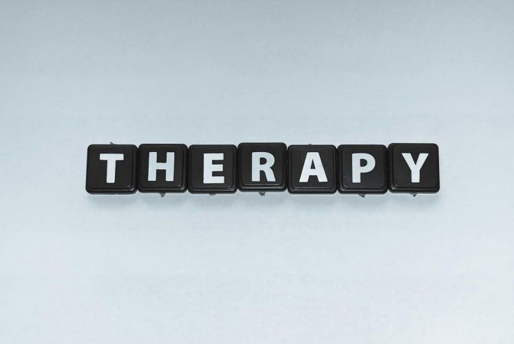 Black letter tiles spell out the word 