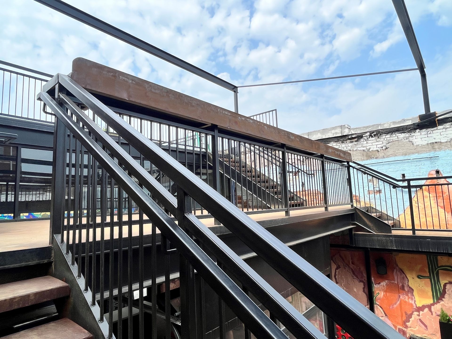 A large empty room with a balcony and a concrete floor.