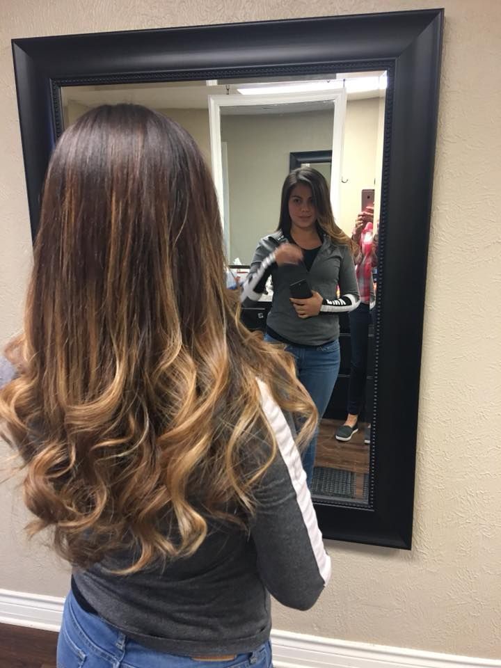 A woman is taking a picture of herself in a mirror.