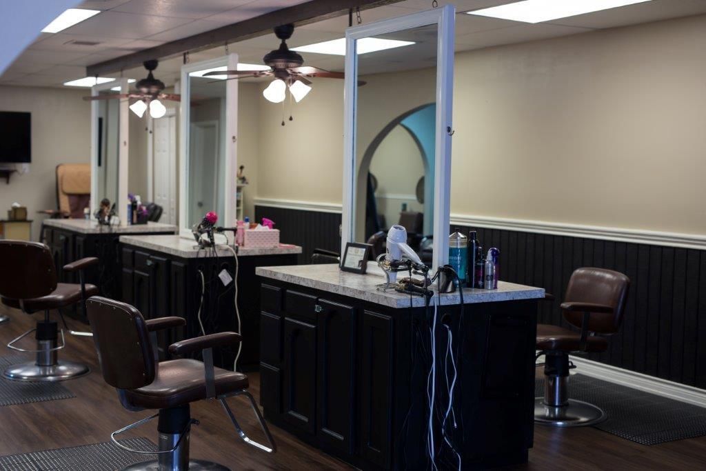 A hair salon with a lot of chairs and a counter
