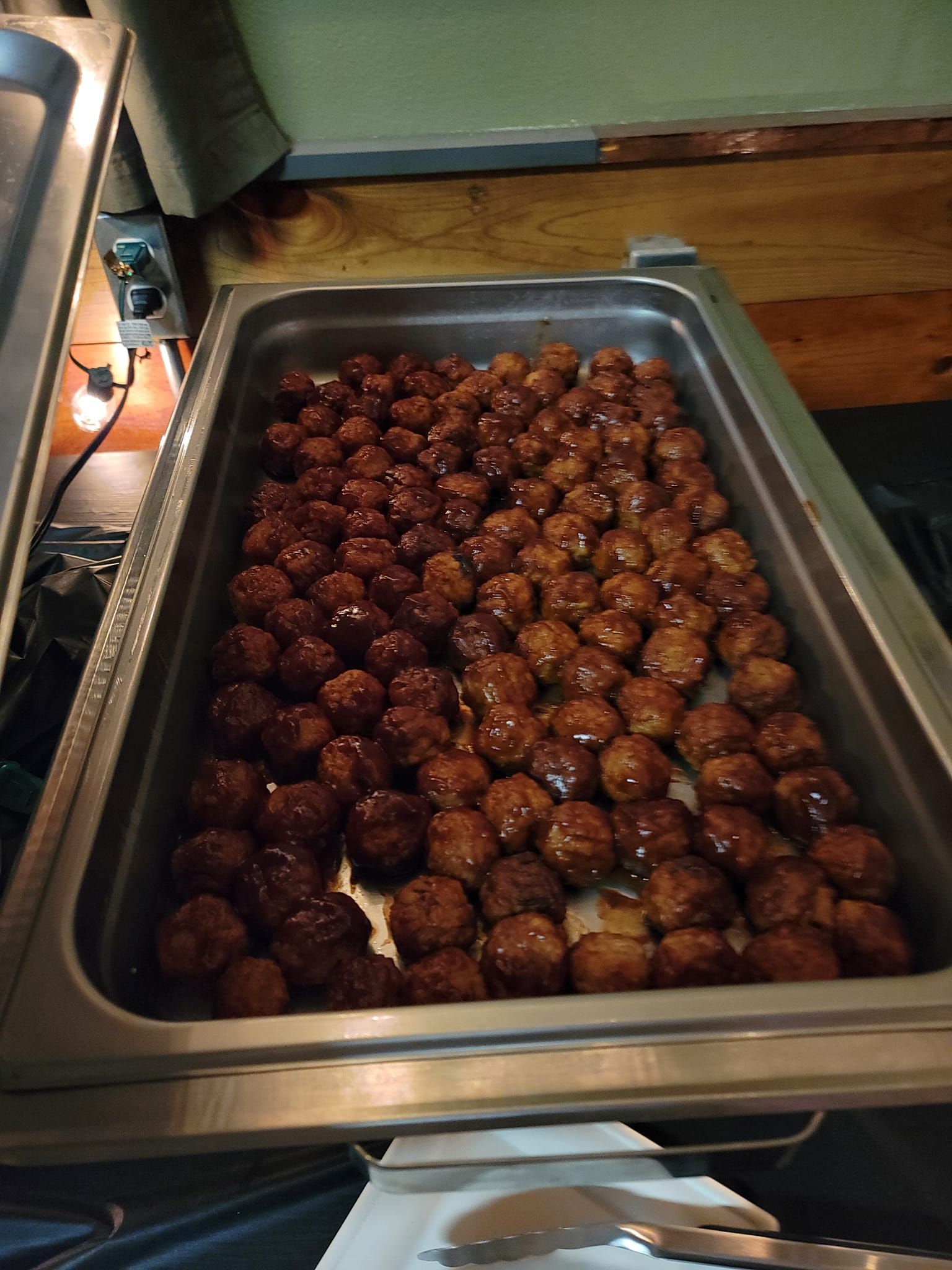 A tray of pulled pork is sitting on a counter.