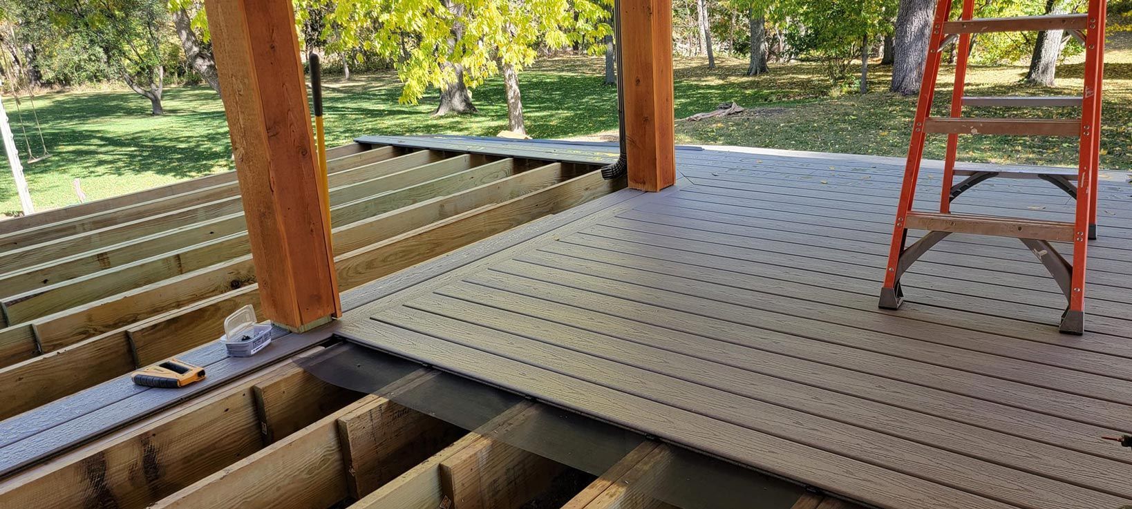 A ladder is sitting on top of a wooden deck.
