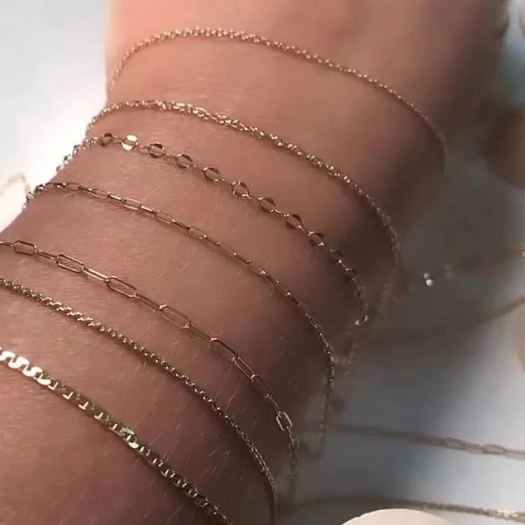 A close up of a person 's wrist with bracelets on it