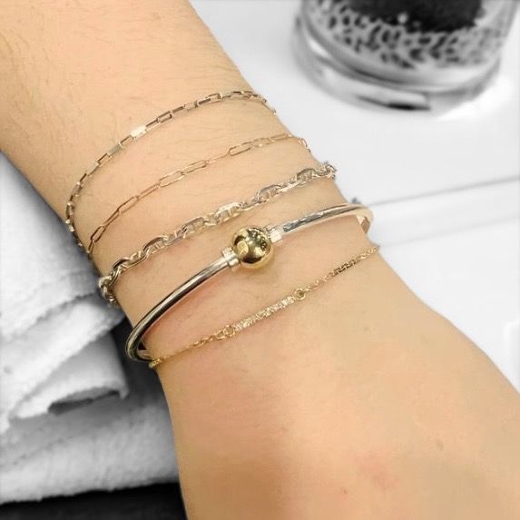 A close up of a woman 's wrist with several bracelets on it