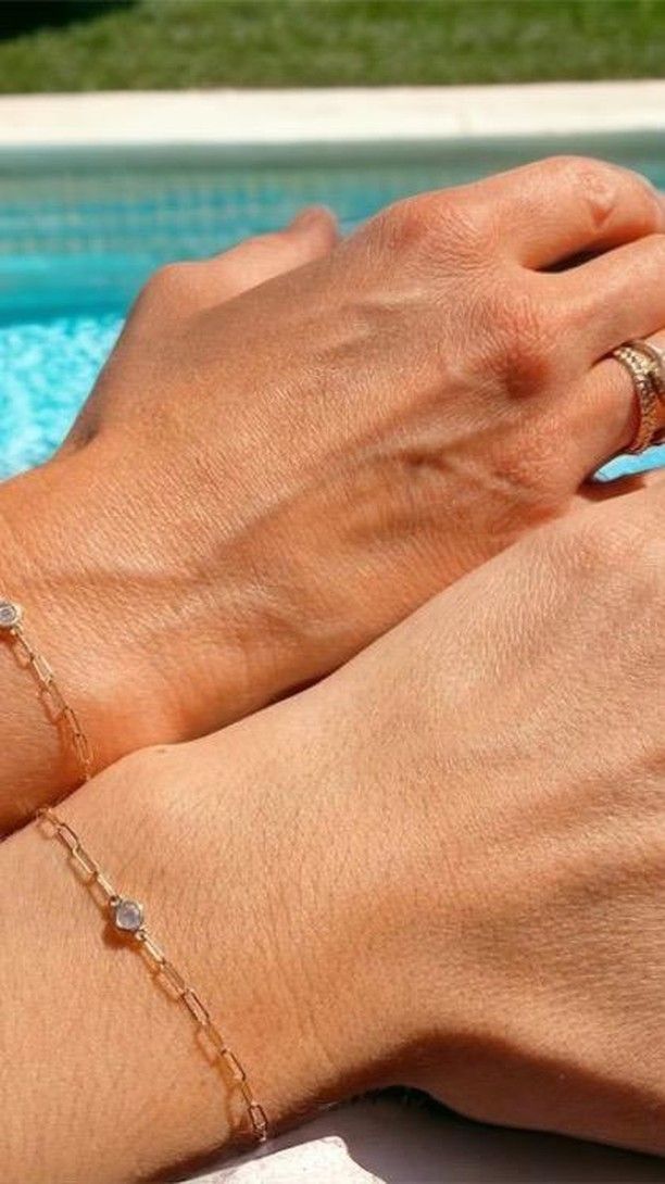 A man and a woman are holding hands and wearing bracelets.