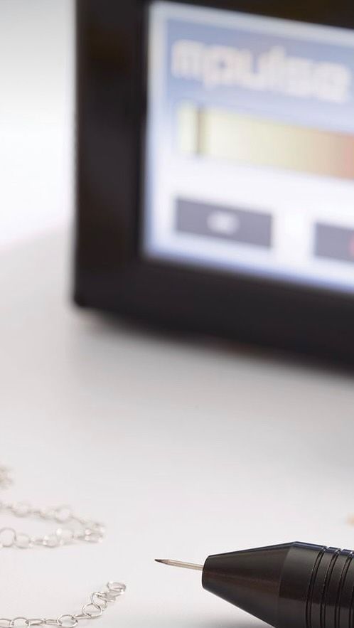 A pen is sitting on a piece of paper with a screen in the background.