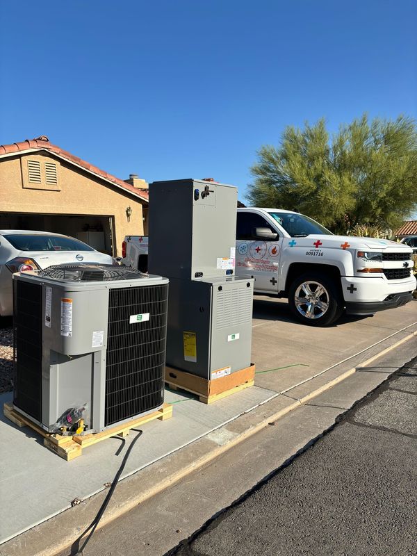 A large air conditioner is sitting on a sidewalk next to a wall.