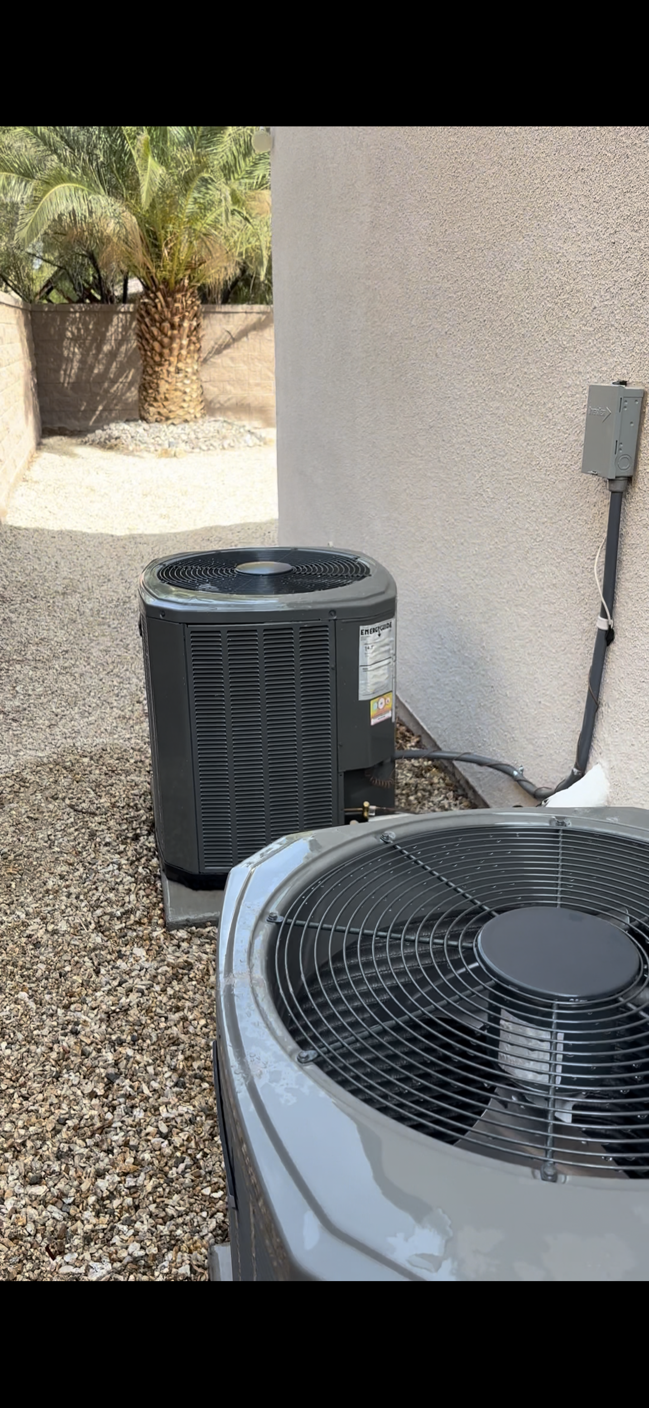 A furnace is being repaired in a garage with a voltmeter attached to it.