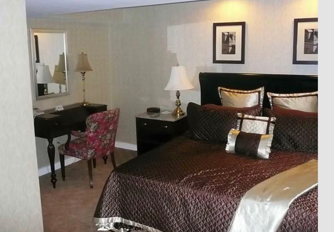 Reception desk with portraits of historical figures. Wall display features black and white images.