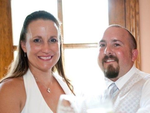 Jason West, Wheat State Insurance Group Agent, and his wife, Sydney celebrate with glasses of champagne