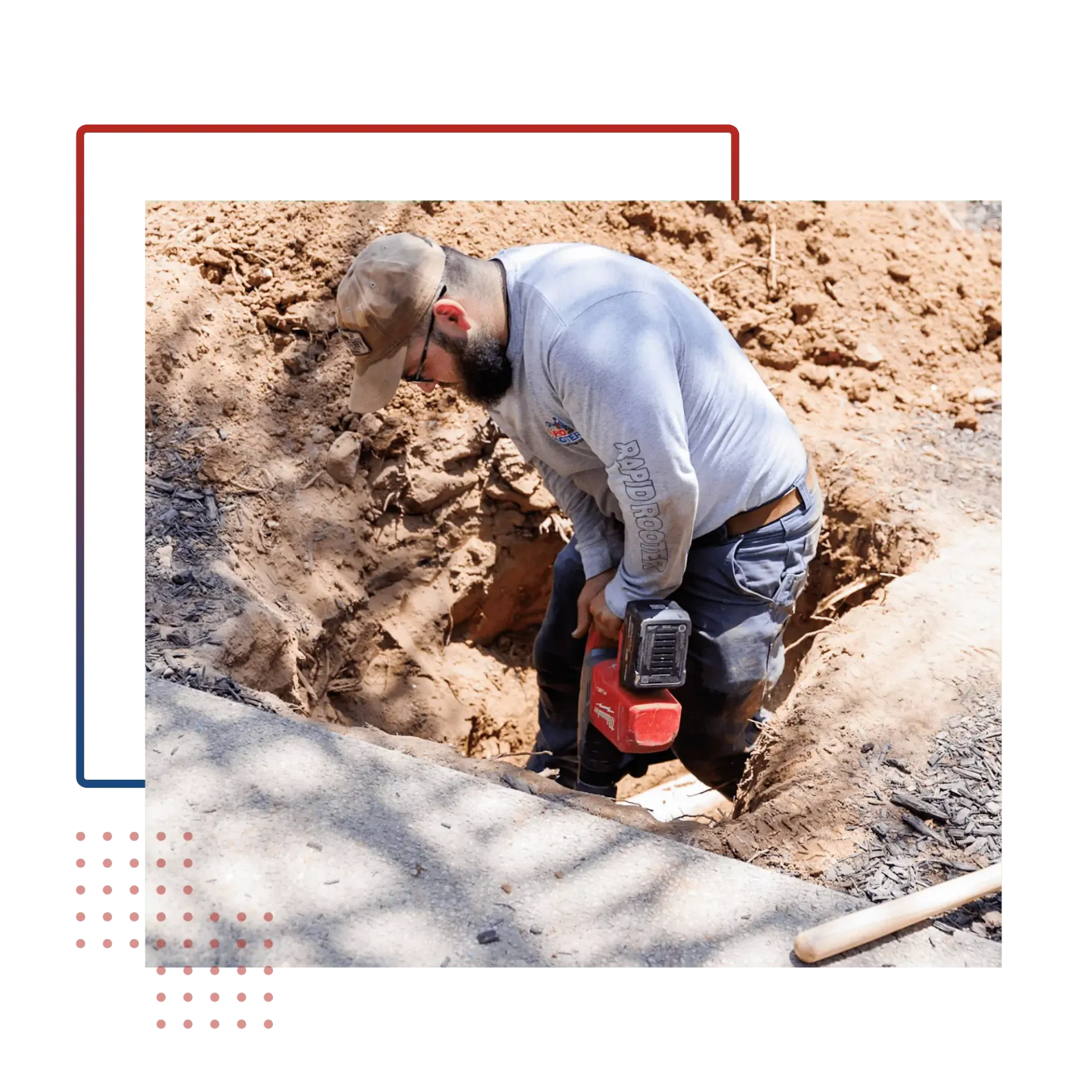 A man is digging a hole in the ground with a drill.