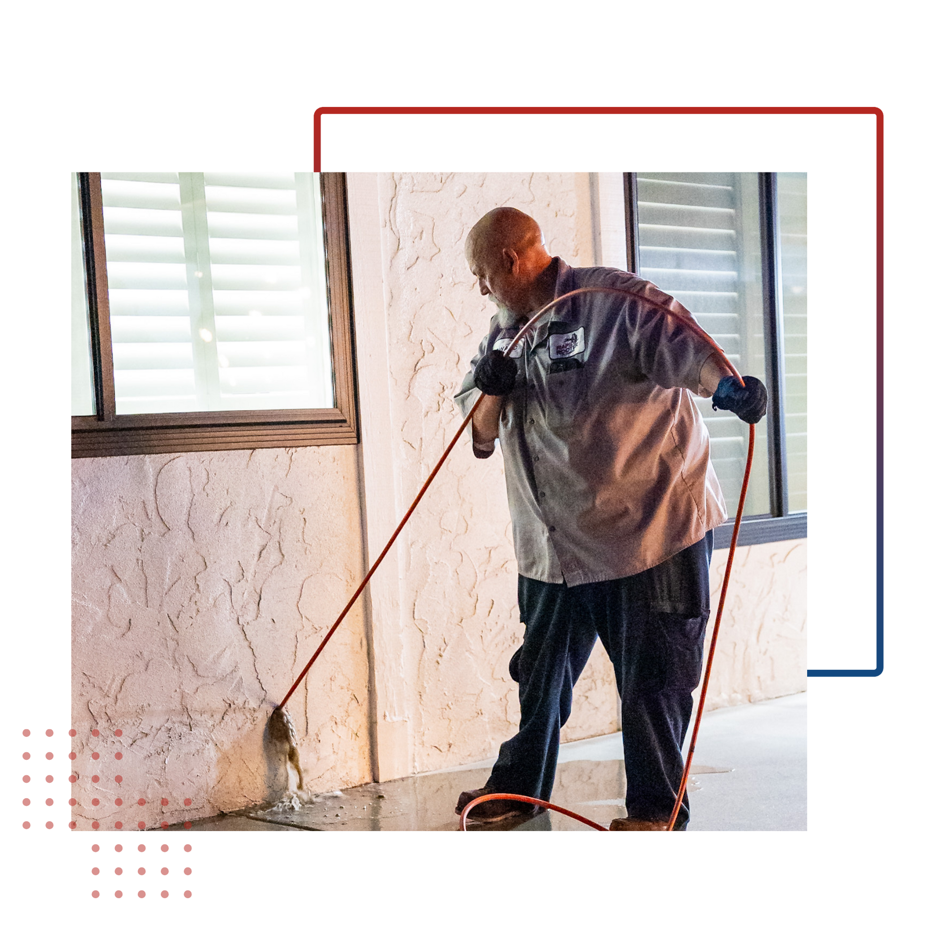 A plumber is using a machine to clean a drain in a bathroom.