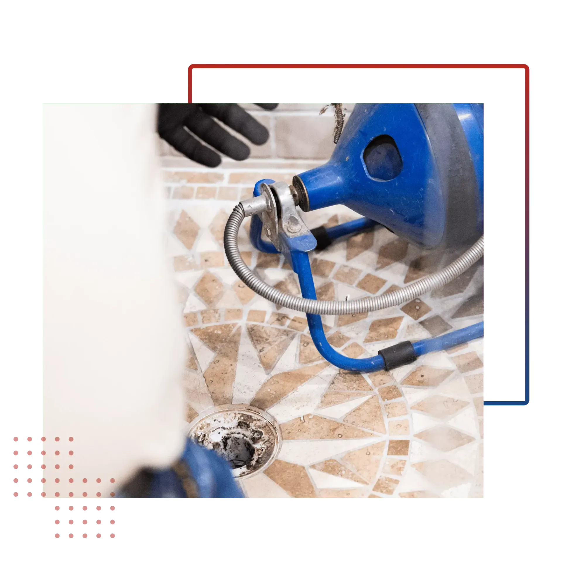 A plumber is using a machine to clean a drain in a bathroom.