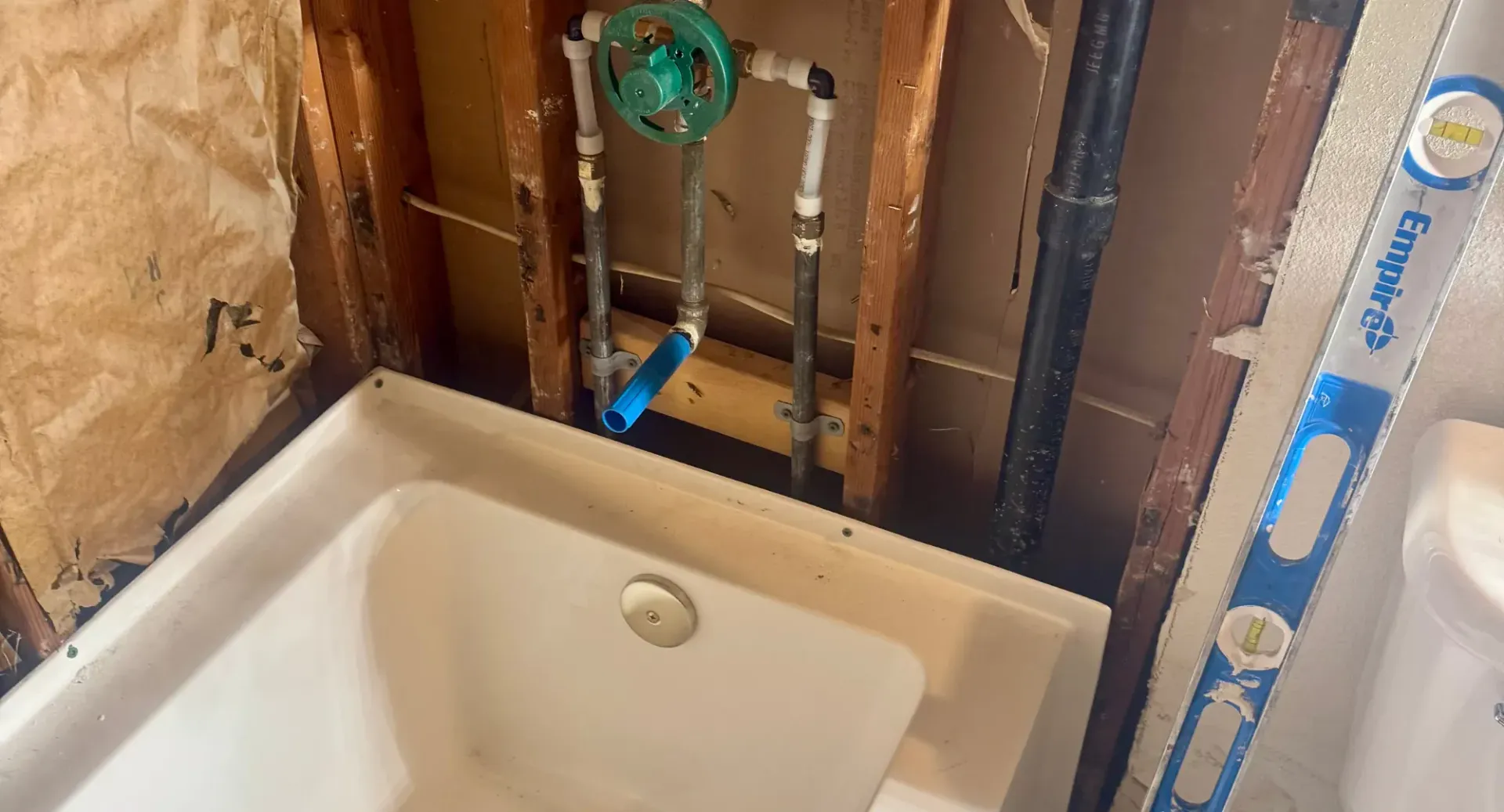 A bathtub is being remodeled in a bathroom.