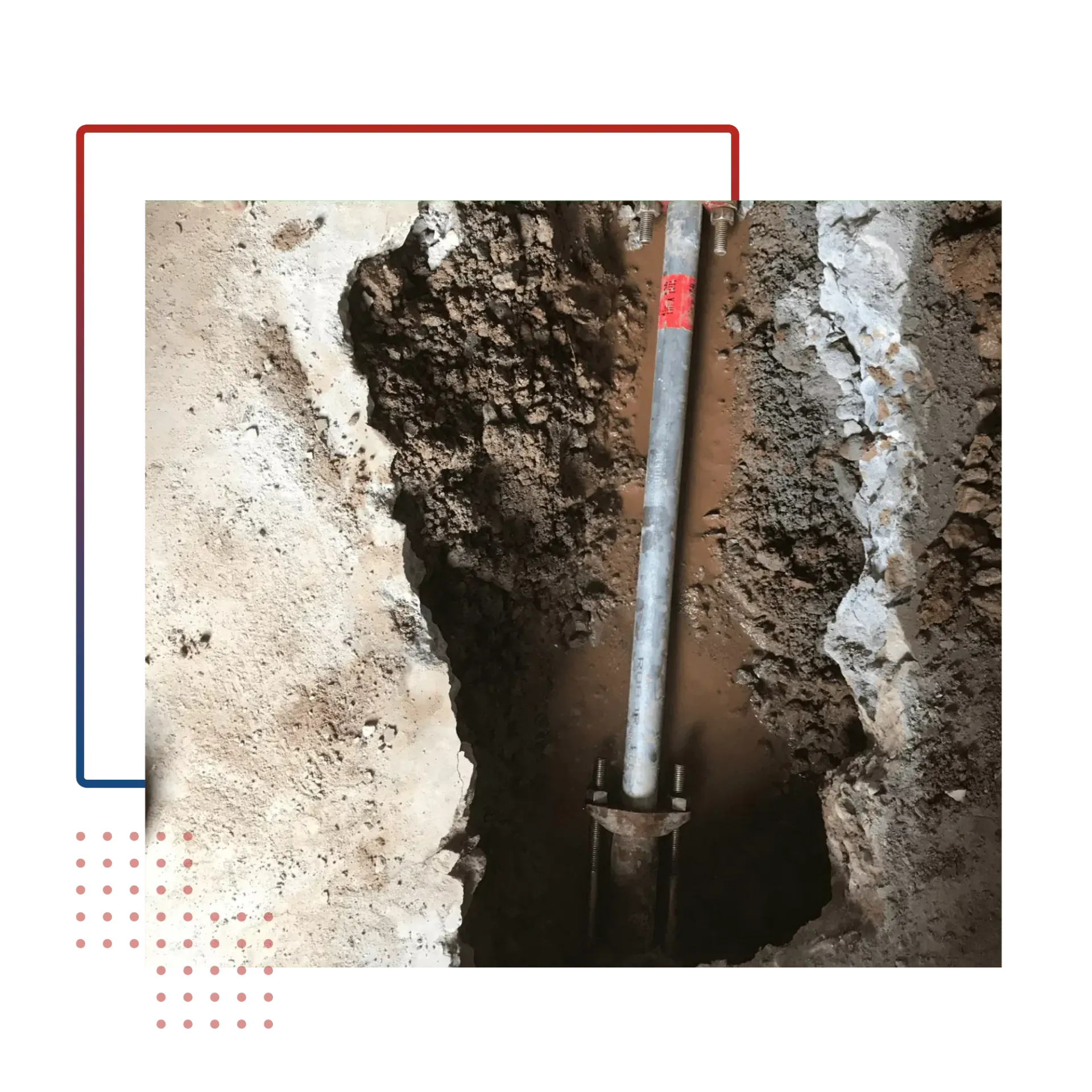 A metal pipe is sticking out of a hole in the ground.